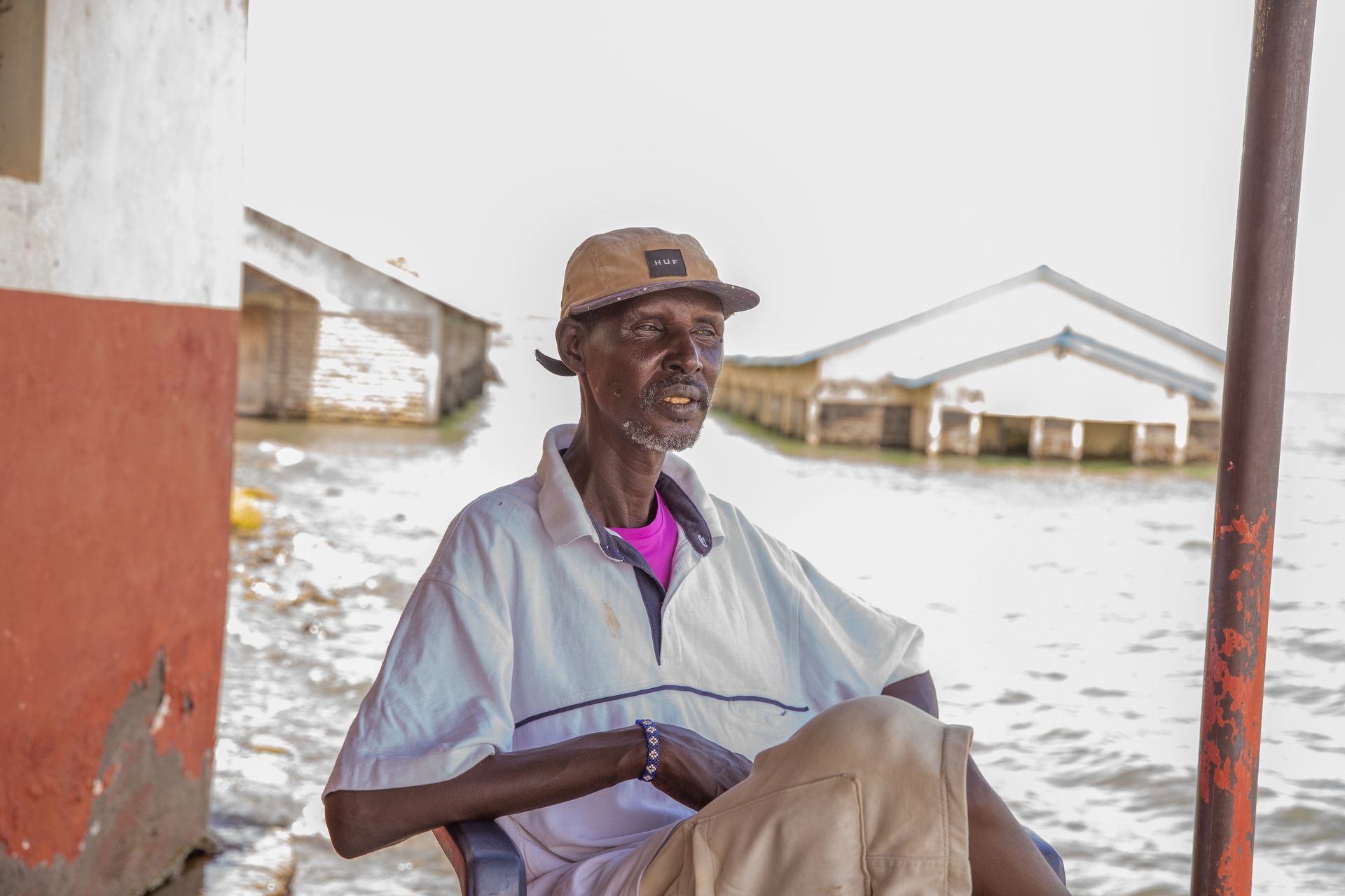 Portrait of an elder seated beside the lake.