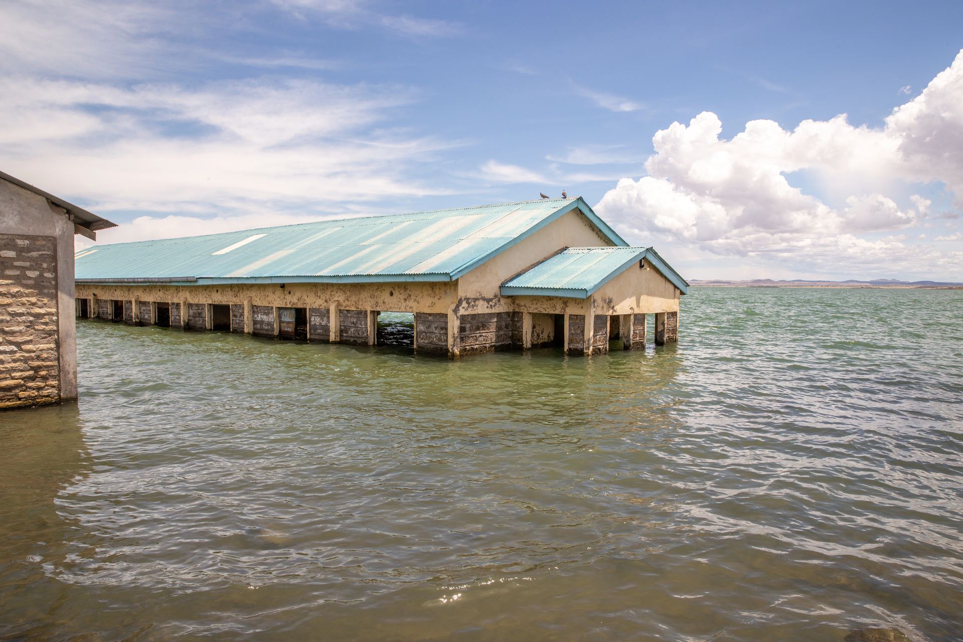 A wide view of a partially flooded lakeside settlement.