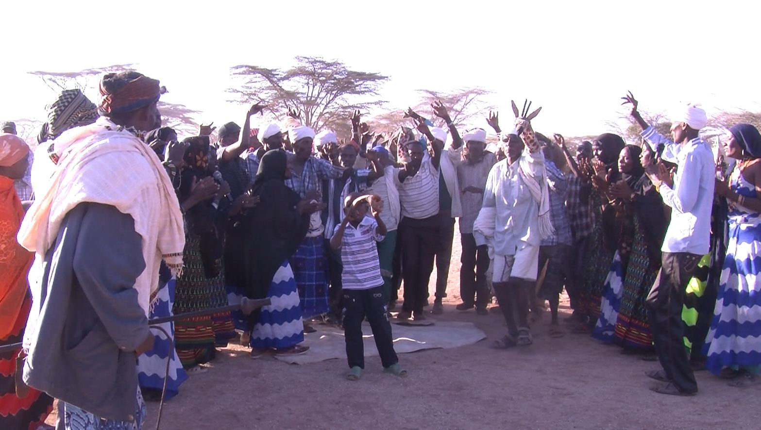 Community members raise their hands in celebration.