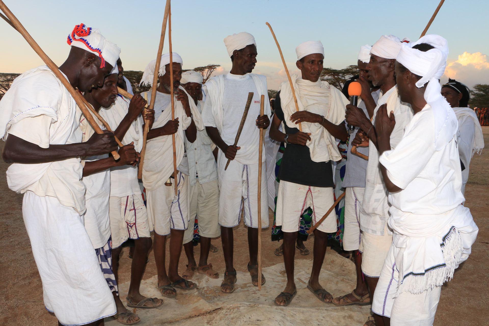 Elders in white robes with staffs at Kalacha Cultural Festival