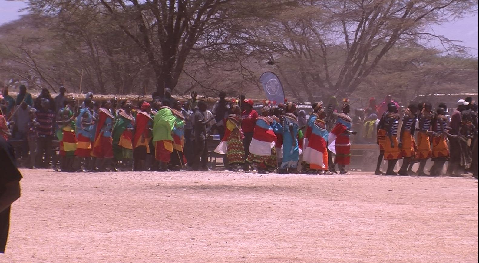 Women form a circle for a traditional performance.