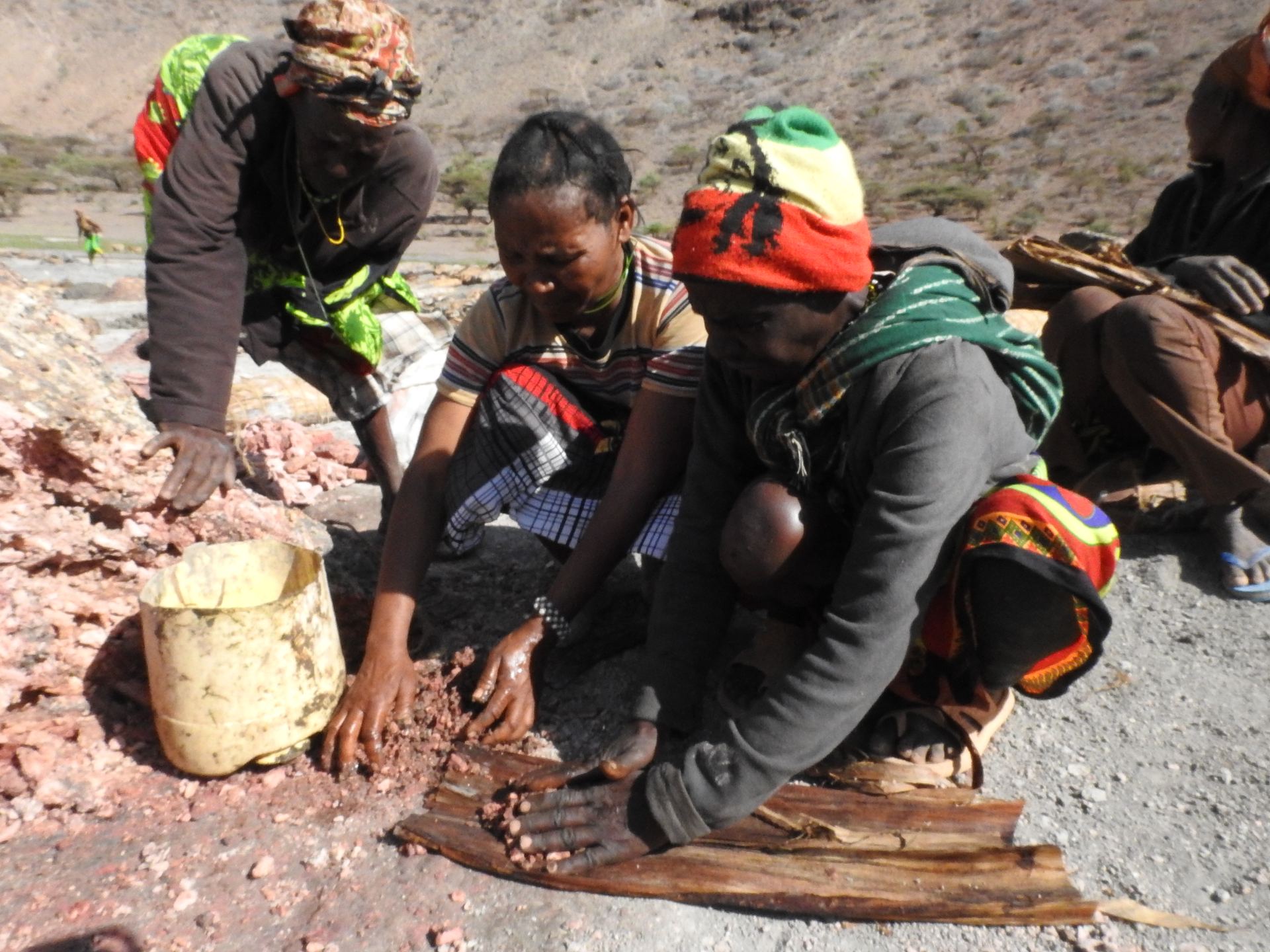 Elders demonstrating traditional fire-making techniques.