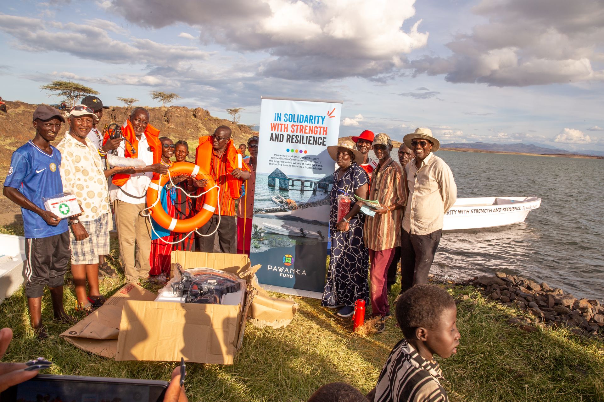 El-Molo elders seated together by the lake.