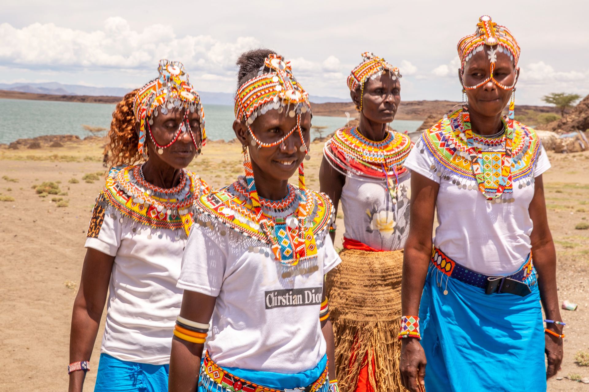 Four women in traditional dress pose together.